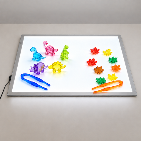 Illuminated A2 light panel with dinosaur and leaf counters and translucent tweezers